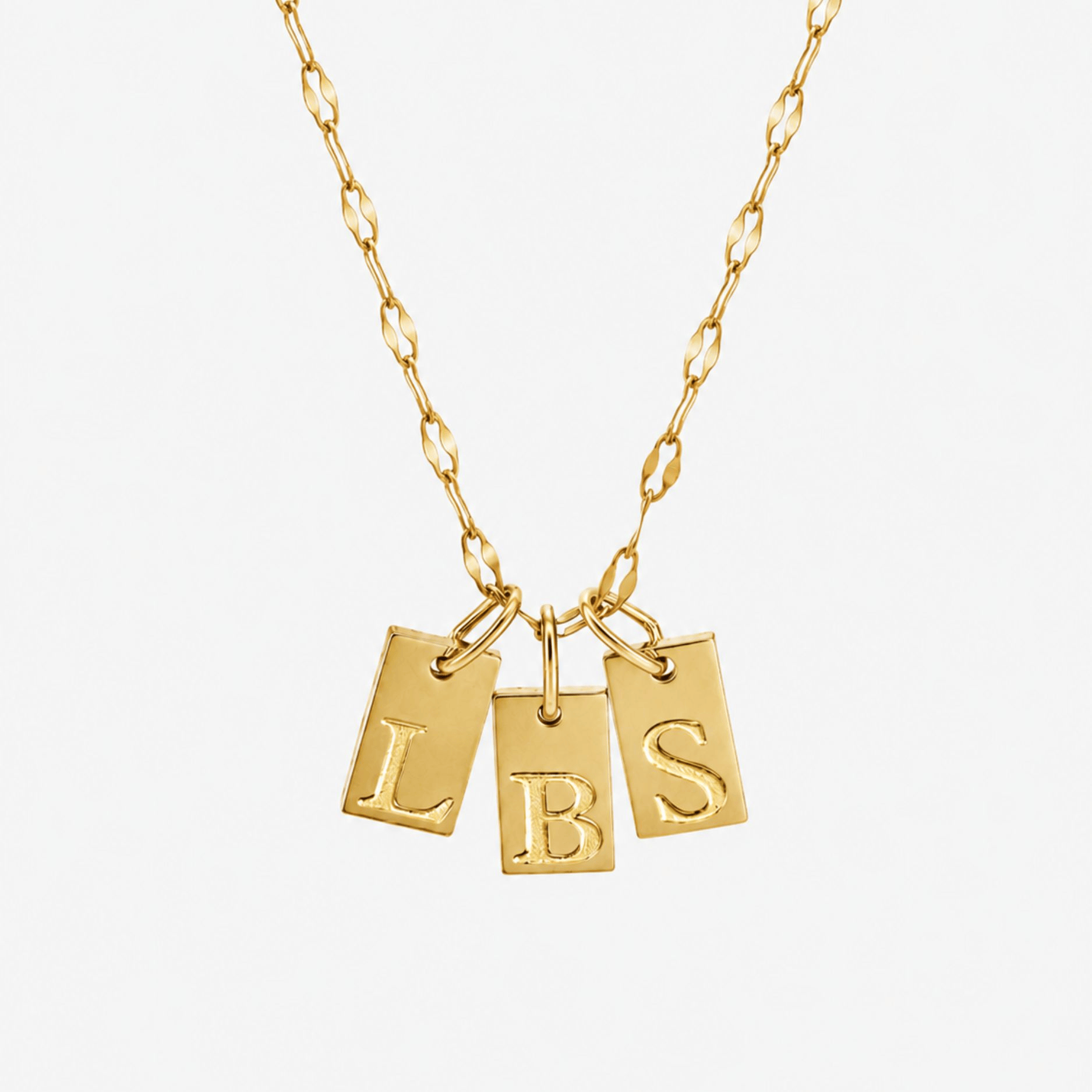 Gold initial tag necklace with three engraved letter charms