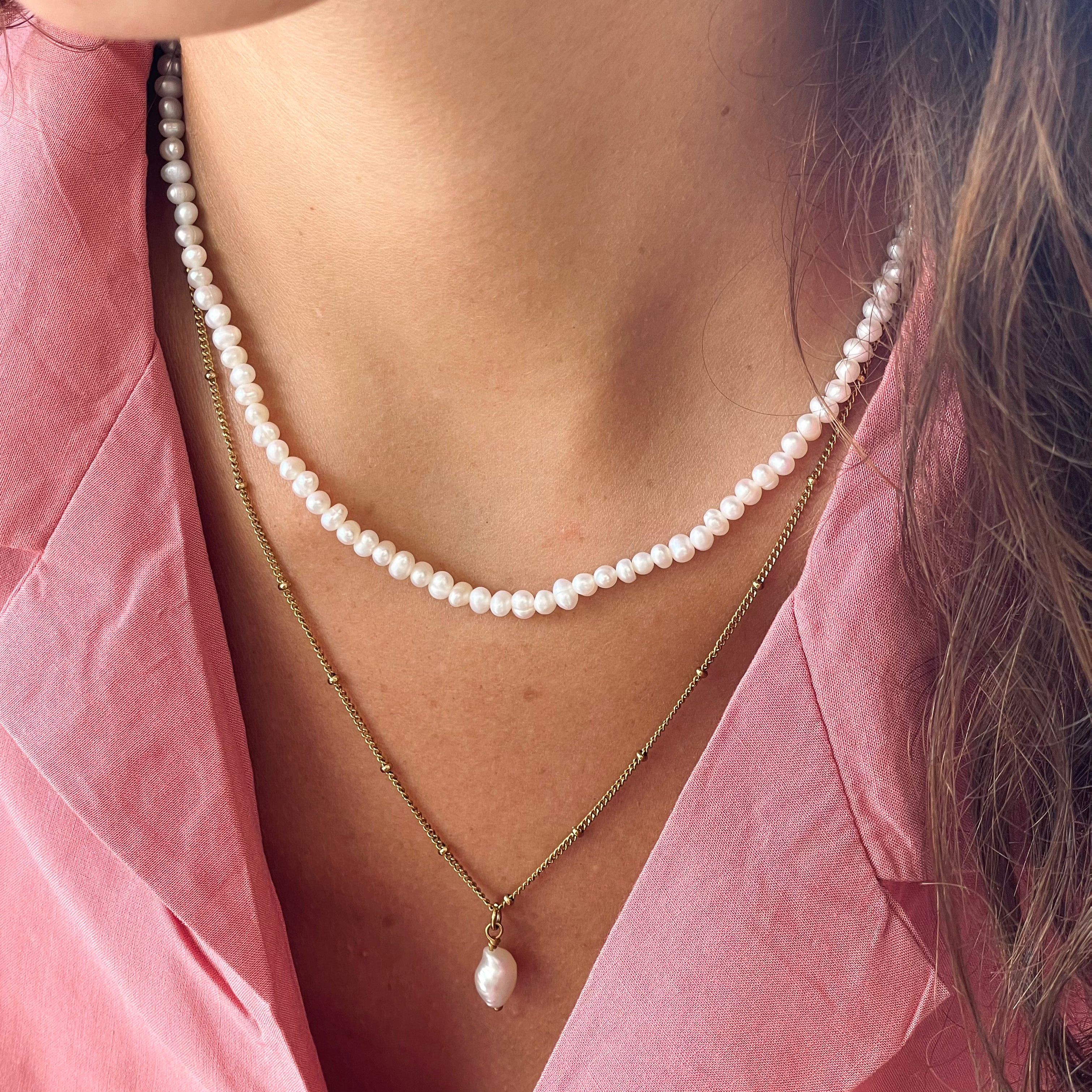 Mini freshwater pearl choker layered with a gold pearl pendant necklace